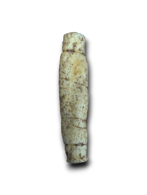 Antique carved ivory or bone cylinder with weathered texture on black background